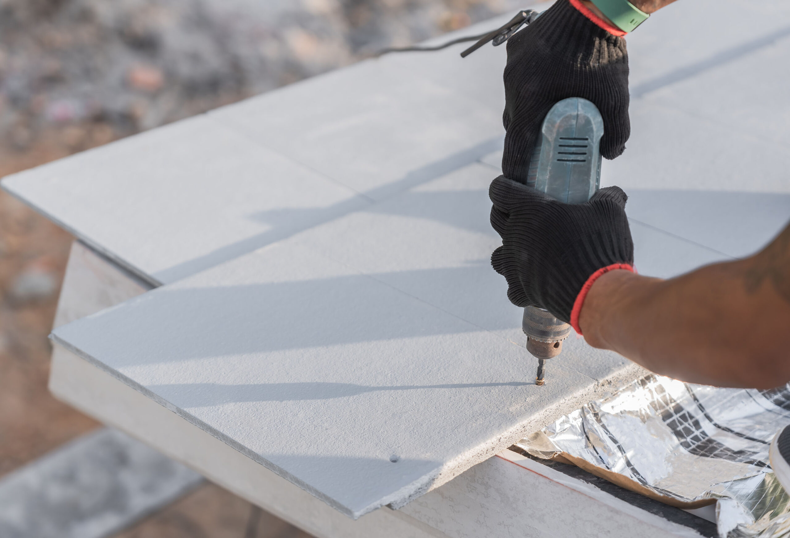 hand worker installing white-roof tiles and fix