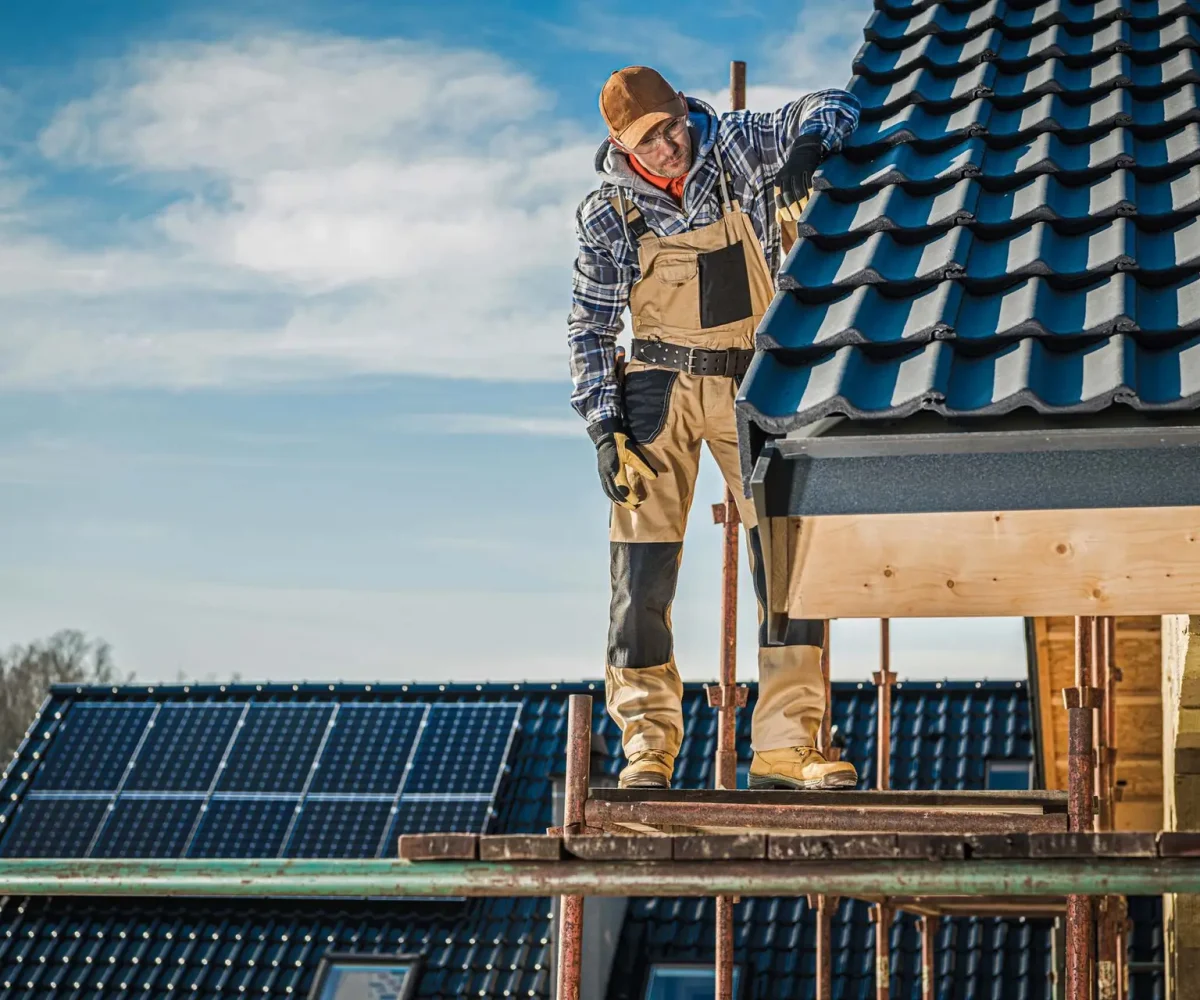 house-roof-construction-2023-11-27-05-23-20-utc Commercial Roofing System: A professional roofer checking work quality on the roof